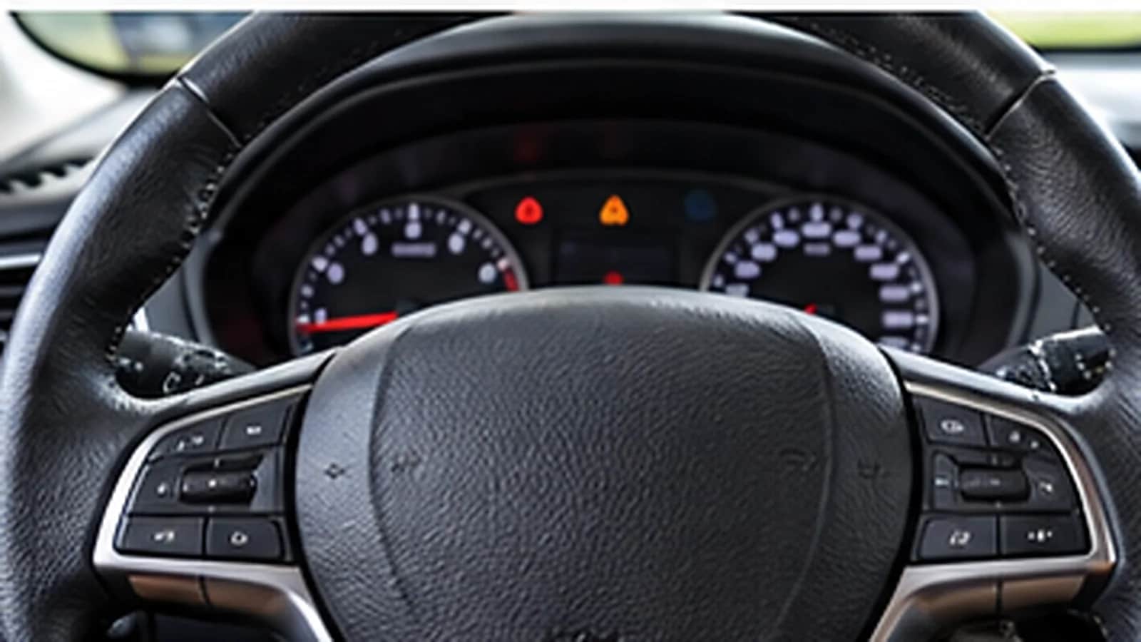 A steering wheel and instrument cluster seen from the driver seat